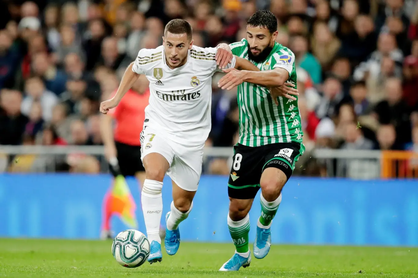 Real Madrid No.7 contests the ball with Real Betis No.8 — image for 1xBet Aviator Predictor page