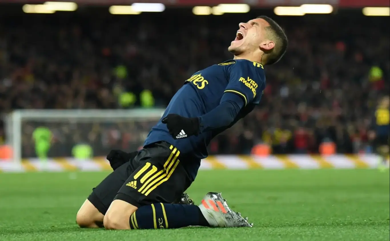 Player kneeling and celebrating passionately on the pitch — image for 1xBet Bonus page