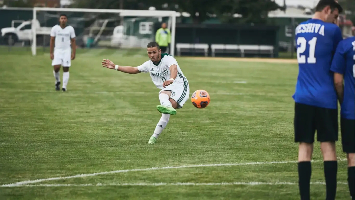 Player taking a free kick as defenders form a wall - image for 1xBet APK page